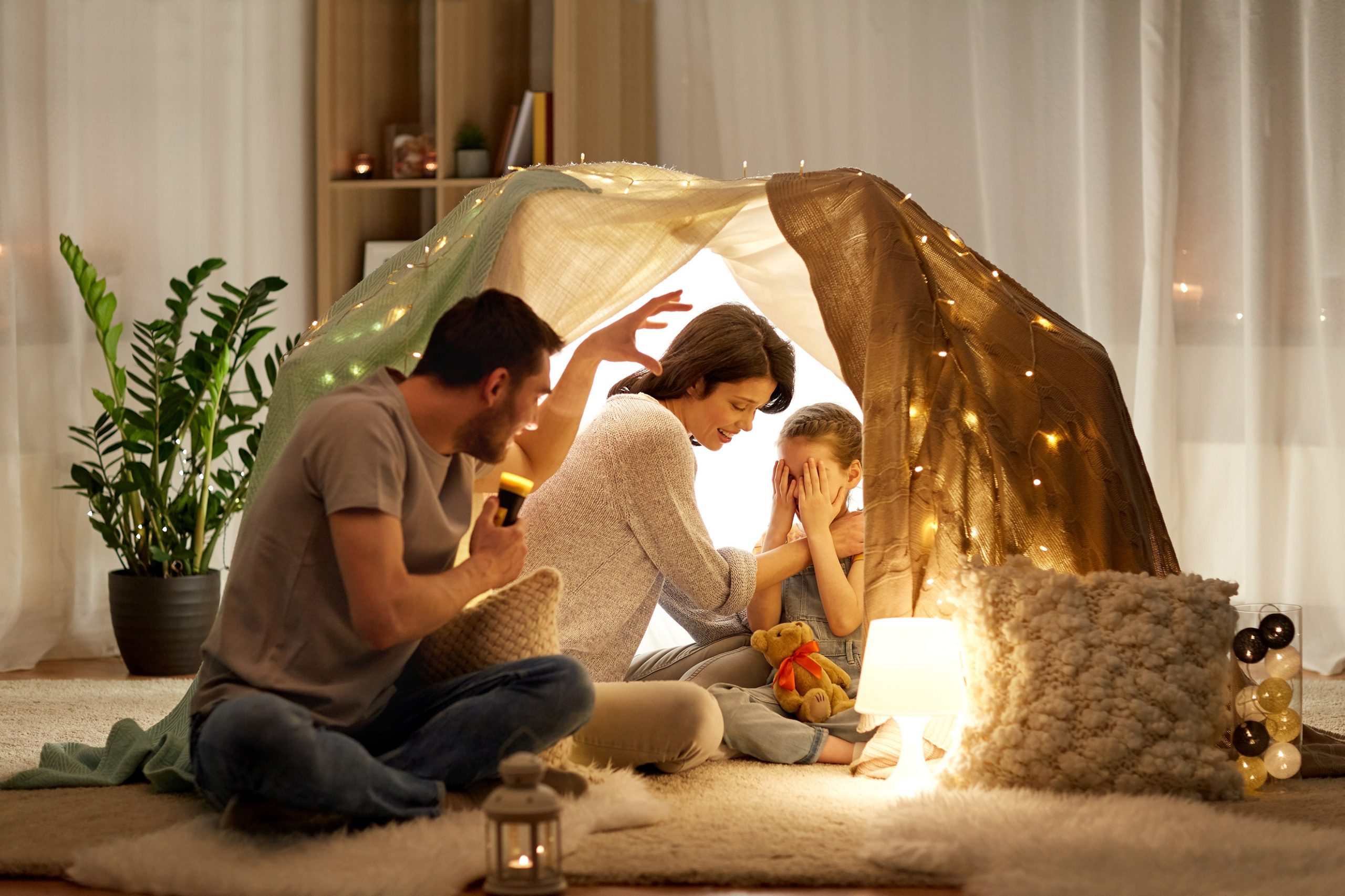 father telling scary stories to his daughter